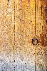 Cracked wooden surface of an old door damaged by woodboring beetles at Kavala, Greece, texture background