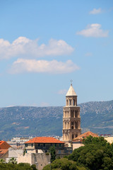 Fototapeta na wymiar Saint Domnius bell tower, landmark in Split, Croatia, surrounded with trees.