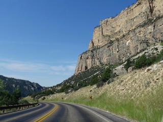 Scenic drive and view with a smooth paved road cutting through the Bighorn Mountains in Wyoming.