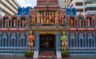 Naklejka premium Colourful statues of Hindu religious deities adorning the entrance of sri krishnan temple 