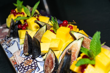 an amazing fruit salad of mango and passion fruit served on a funky skate board deck 