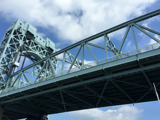 Robert F. Kennedy Bridge with blue sky and cloud view from the river, New York City.