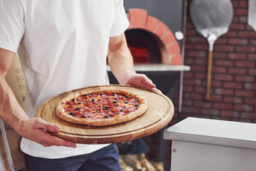 Have a good meal. Picture of prepared delicious pizza with sausage rings and olives