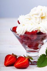 Strawberries and cream in a transparent bowl