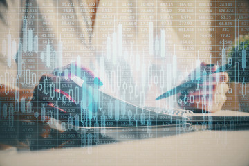 Financial chart drawn over hands taking notes background. Concept of research. Multi exposure