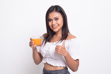 Young Asian woman thumbs up drink orange juice.