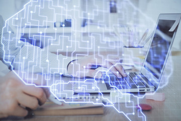 Man typing on keyboard background with brain hologram. Concept of big Data. Double exposure.