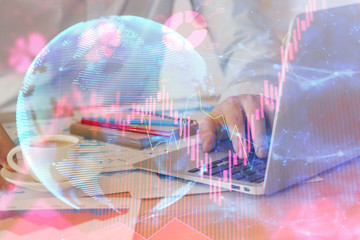 Double exposure of businessman working on laptop on background. International business hologram in front. Concept of success.