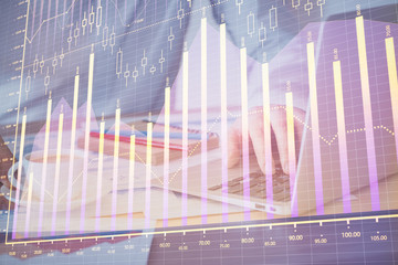 Forex graph with businessman working on computer in office on background. Concept of hardworking....
