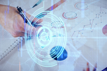 Writing man's hand with technology icons.