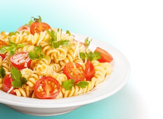 Spaghetti pasta with tomatoes and parsley on  table.