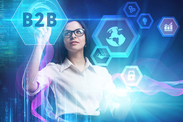The concept of business, technology, the Internet and the network. A young entrepreneur working on a virtual screen of the future and sees the inscription: B2B