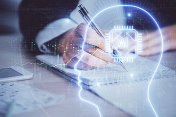 Double exposure of woman's writing hand on background with brain hud. Concept of learning.