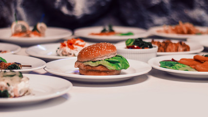 hamburger and many other snacks on the table