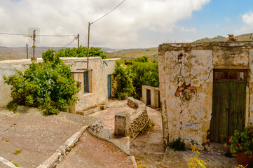 Fototapeta na wymiar Old abandoned town. Narrow street in old Greek village.