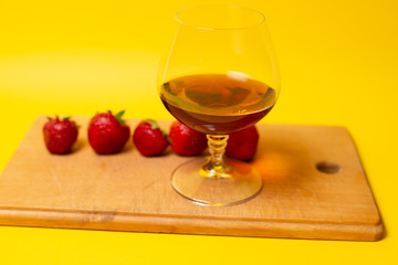 glass of red wine and grapes on wooden table