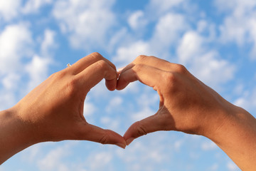 Heart symbol and the blue cloudy sky