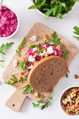 beetroot and feta cheese sandwich with walnuts and rocket