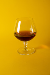glass of brandy on black background