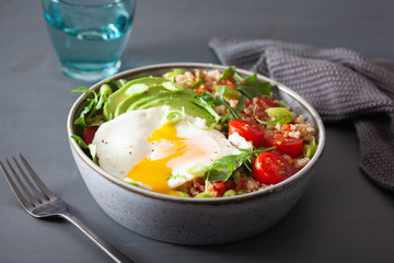 quinoa bowl with fried egg, avocado, tomato, rocket. Healthy vegetarian lunch