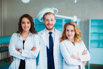 Medical students profession staff. multinational people - doctor, nurse and surgeon. A group of graduates of a medical university in a surgical room.