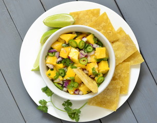Homemade Mango Salsa with Ingredients and Corn Chips,  view from above