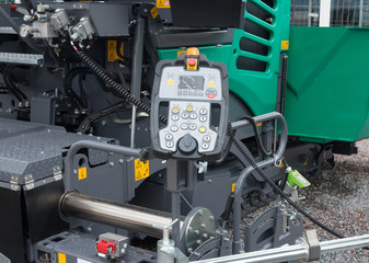 Large asphalt paver. Pavement truck remote control console closeup