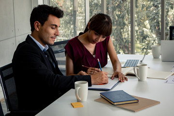 Business men and women signed a joint business agreement.