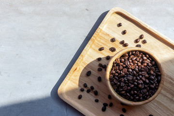 coffee bean in wooden cup on desk background