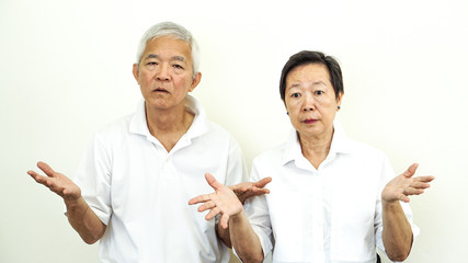 Asian senior couple unhappy angry deal with problem gesture expression