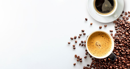 hot espresso and coffee bean on white table with soft-focus and over light in the background. top...