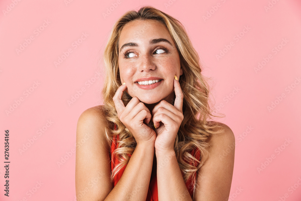 Sticker Cheerful cute pretty happy young cute blonde woman posing isolated over pink wall background.