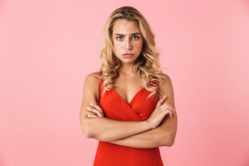 Displeased offended cute young blonde woman posing isolated over pink wall background.