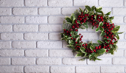 Christmas wreath on brick wall background