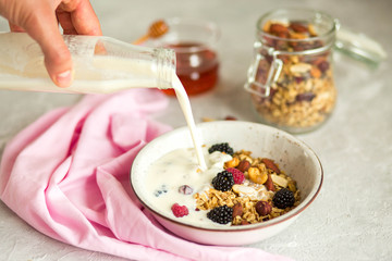 Granola with yogurt, honey and berries. Breakfast with berries and nuts. The correct breakfast. Delicious dish in the morning