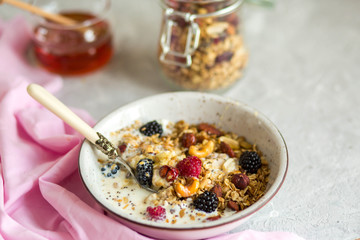 Granola with yogurt, honey and berries. Breakfast with berries and nuts. The correct breakfast. Delicious dish in the morning