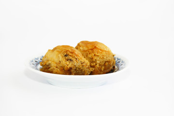 traditional Turkish baked sweetness baklava with honey on colorful plate