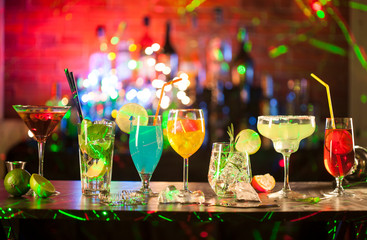 Set with different cocktails on bar tender