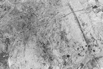 Vintage monochrome background. Rough painted wall of black and white color. Imperfect plane of grayscale. Uneven old decorative backdrop. Texture of black-white. Monochromatic ornamental stony surface