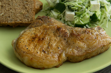 Pork on the bone, coleslaw, cheese and pickled cucumbers, whole grain bread