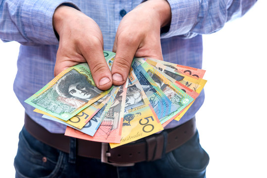 Man showing fan of australian dollar banknotes