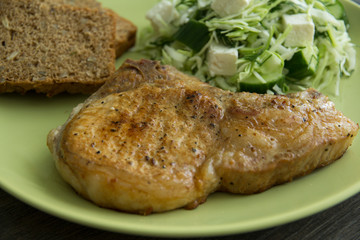 Pork on the bone, coleslaw, cheese and pickled cucumbers, whole grain bread