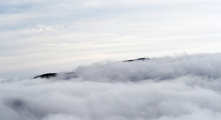 Aerial view of mountains engulfed in clouds