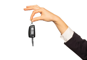 Hand holding car key with index and thumb fingers