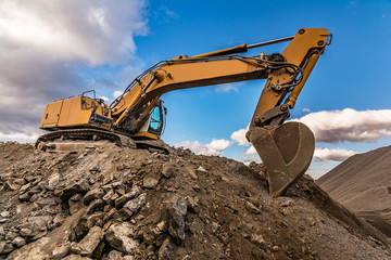 Excavator performing stone extraction work in an open pit stone mine