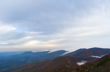 Aerial twilight panorama of mountain forests in autumn colors