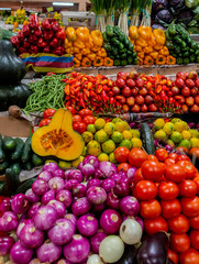 variety of colorful vegetables and legumes at a market stall