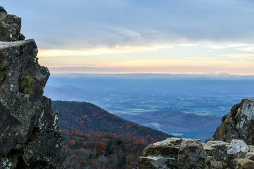 Aerial twilight panorama of mountain forests in autumn colors