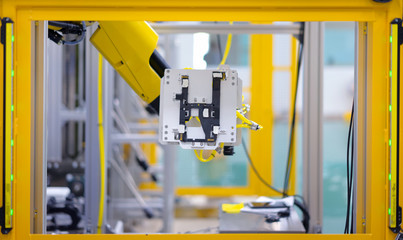 Factory 4.0 concept: View of inspection unit on industrial robt arm at load in port of automation machine.