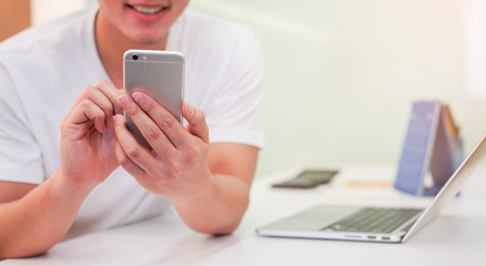 close up hand hold mobile cell phone device:focus on man play on smartphone concept	